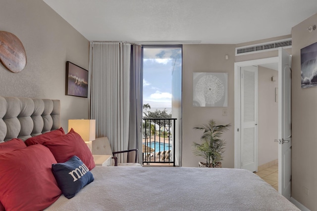 tiled bedroom featuring access to exterior and floor to ceiling windows