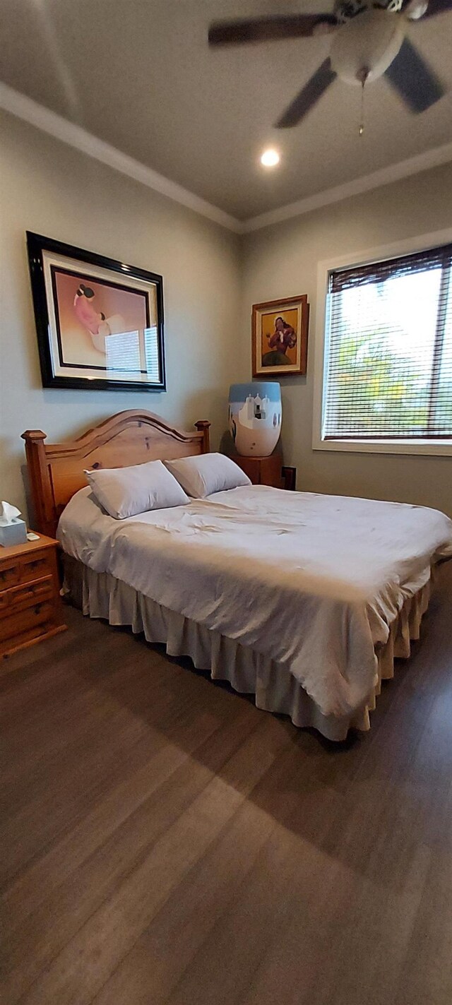 bedroom with ceiling fan, crown molding, and hardwood / wood-style flooring