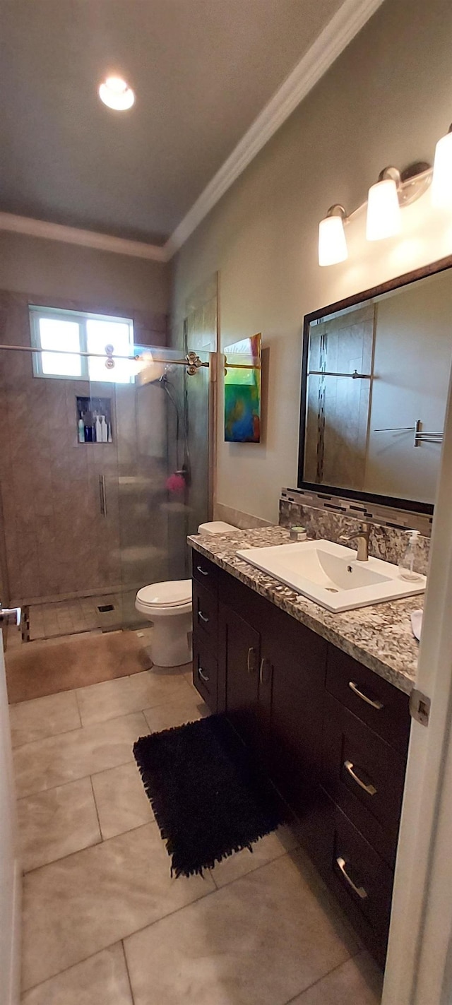 bathroom with tile patterned flooring, vanity, toilet, and ornamental molding