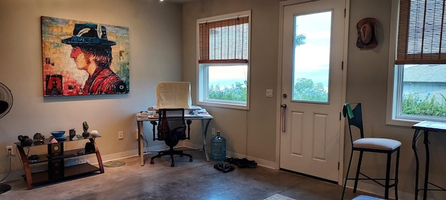 entryway with plenty of natural light and concrete floors