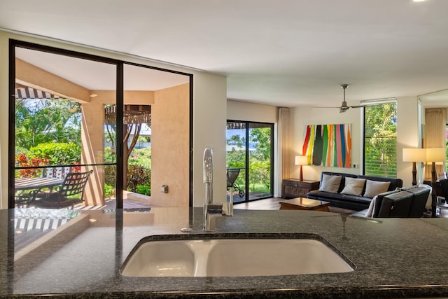 3300 Wailea Alanui St Unit 3A, Kihei, HI 96753 - kitchen with a sink, dark stone countertops, a ceiling fan, and open floor plan