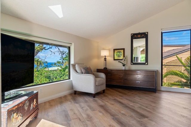 3300 Wailea Alanui St Unit 3A, Kihei, HI 96753 - living area featuring vaulted ceiling, wood finished floors, and baseboards