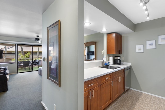 kitchen with dishwasher, light colored carpet, ceiling fan, and sink