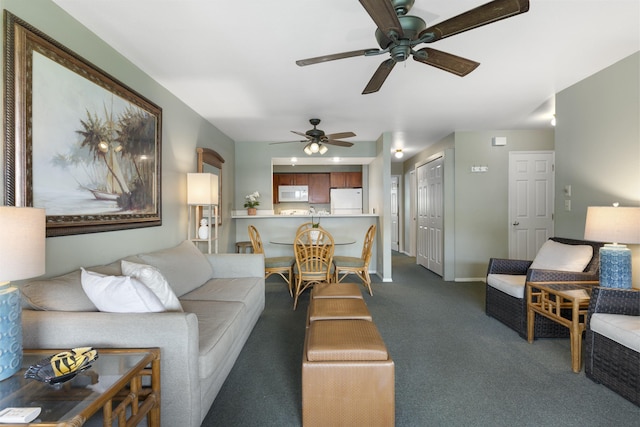 carpeted living room with ceiling fan