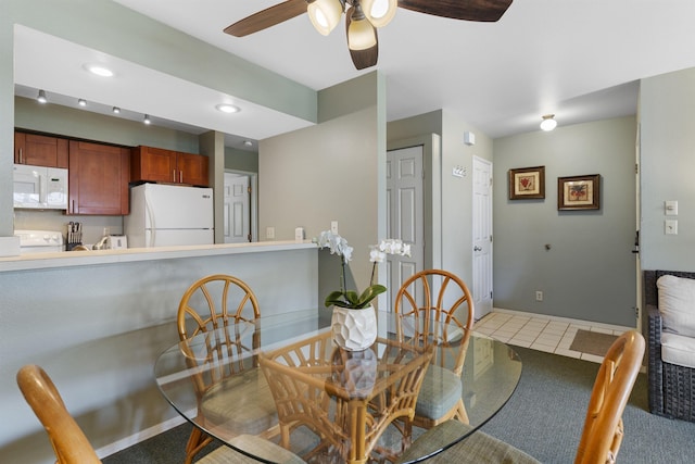 dining area featuring tile patterned floors and ceiling fan