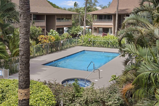 view of swimming pool with a community hot tub