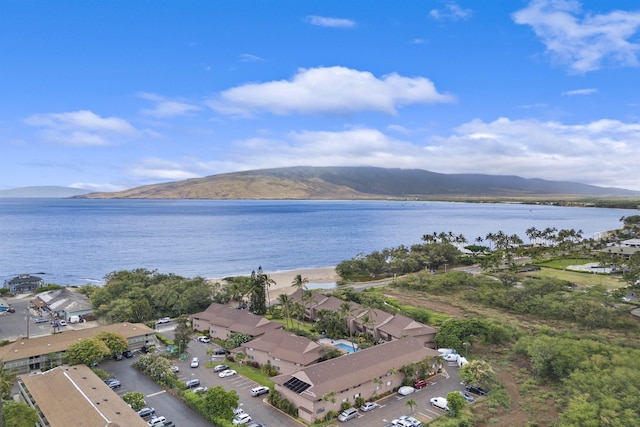 drone / aerial view featuring a water and mountain view