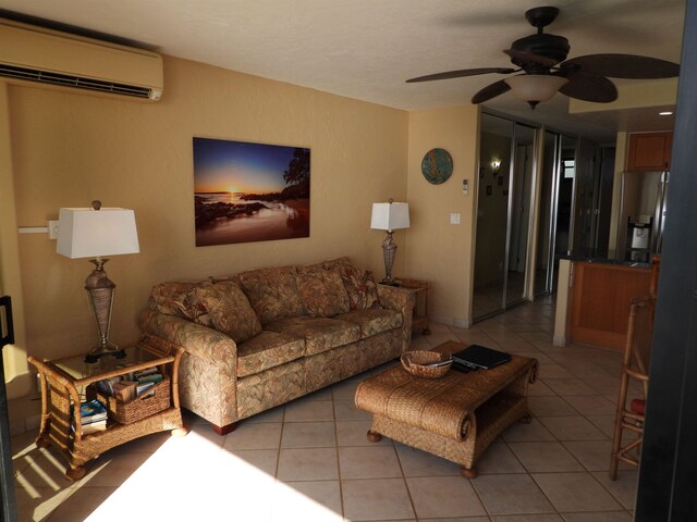 living room featuring a wall unit AC, ceiling fan, and light tile floors