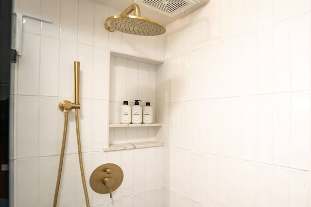 bathroom featuring walk in shower and tile walls