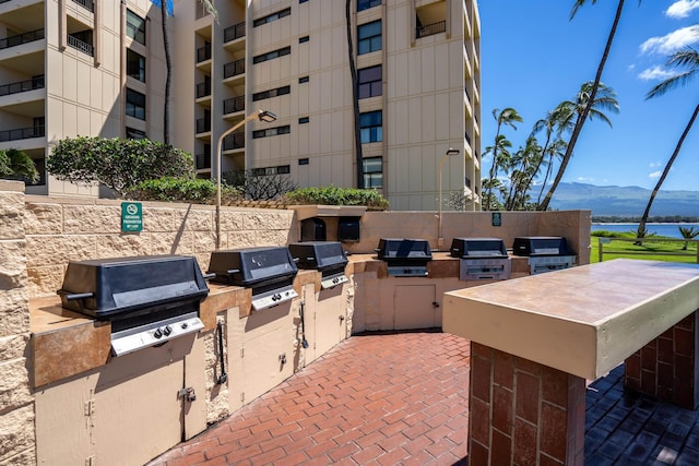 view of patio / terrace featuring a mountain view, area for grilling, and exterior kitchen