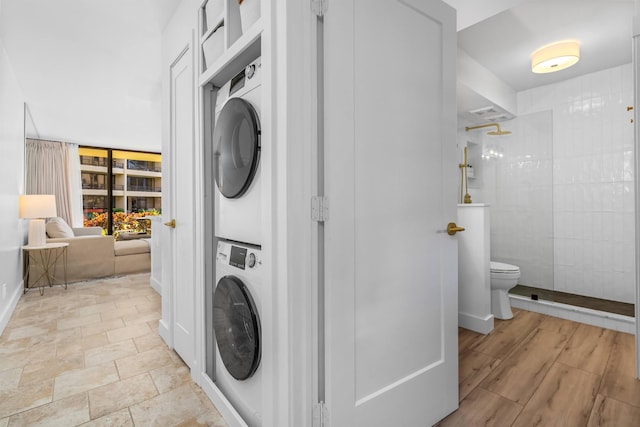 washroom with stacked washer and dryer