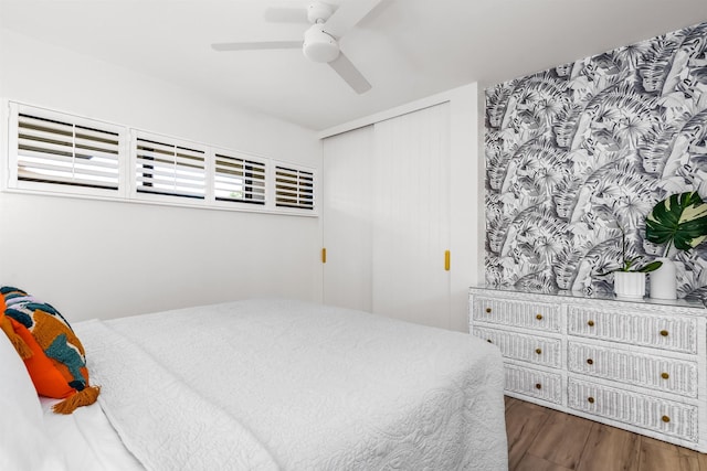 bedroom with ceiling fan and dark wood-type flooring