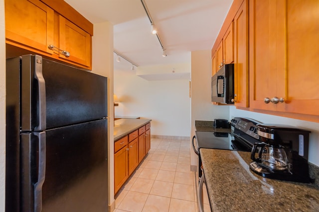 kitchen featuring black appliances, rail lighting, and brown cabinets