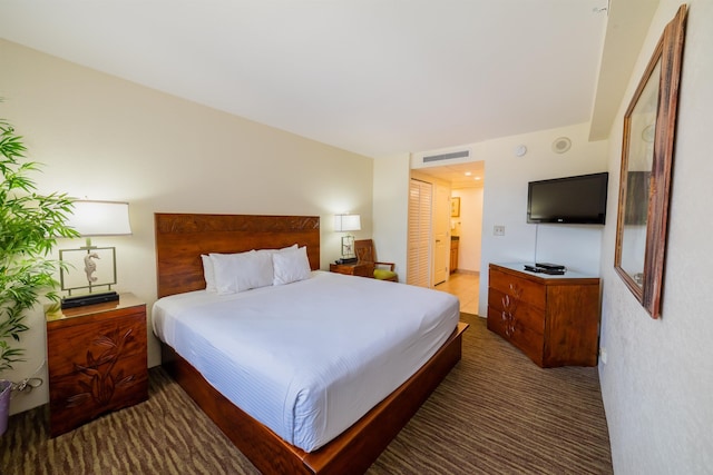 bedroom with visible vents and carpet flooring
