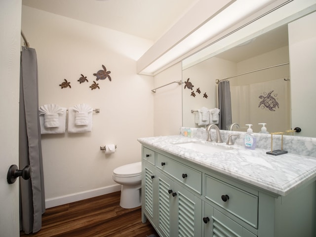 bathroom with vanity, curtained shower, toilet, and wood-type flooring