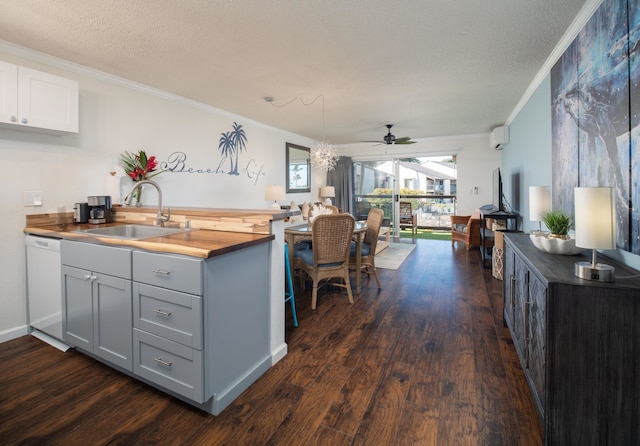 kitchen with butcher block countertops, dishwasher, ceiling fan, and ornamental molding