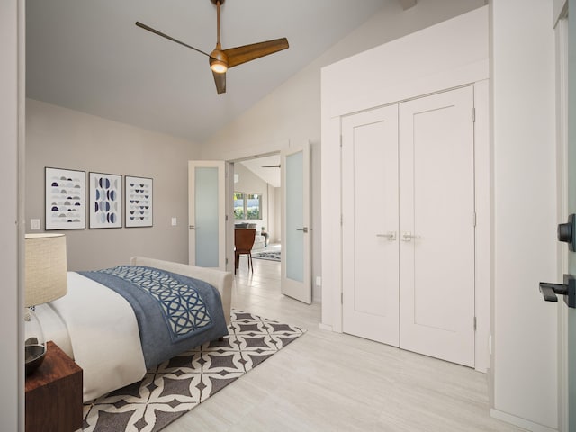 bedroom with lofted ceiling, a closet, and ceiling fan