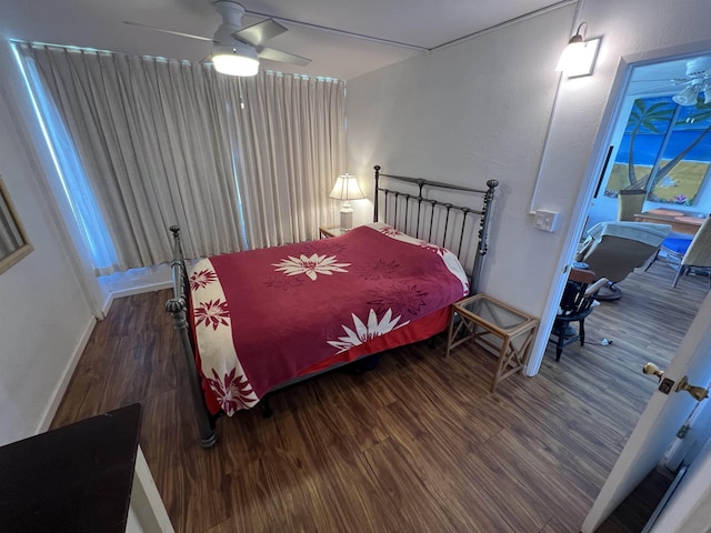 bedroom featuring a ceiling fan, wood finished floors, and baseboards