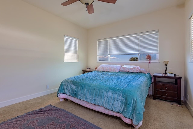 bedroom featuring ceiling fan and light carpet