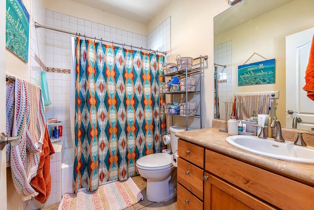 bathroom with vanity, toilet, and tile patterned floors