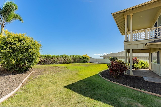 view of yard featuring a balcony and a patio