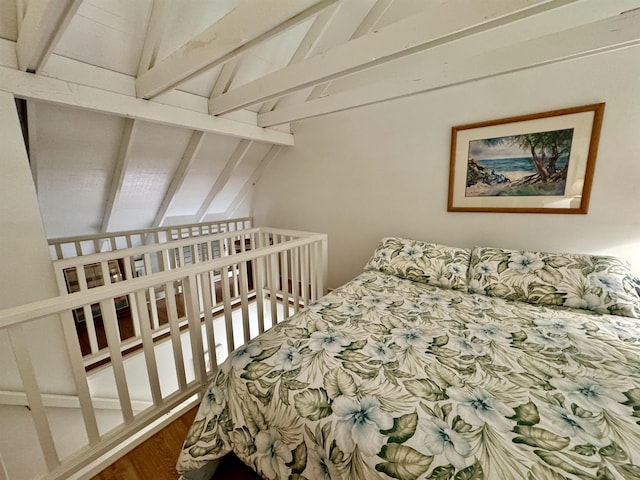 bedroom featuring dark wood-type flooring and lofted ceiling with beams