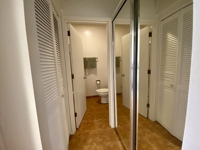 corridor with light tile patterned flooring