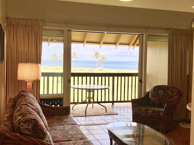 sunroom featuring a water view