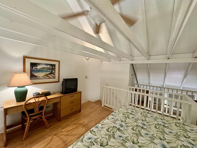 office space with light hardwood / wood-style flooring and lofted ceiling with beams