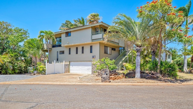 view of front of house featuring a garage and a balcony