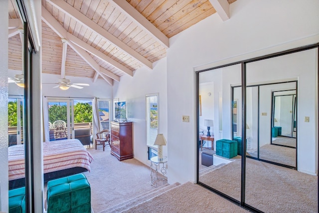 bedroom featuring a closet, beam ceiling, high vaulted ceiling, and light colored carpet