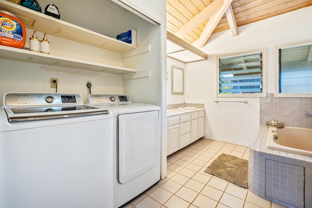 washroom with wood ceiling, independent washer and dryer, sink, and light tile patterned floors