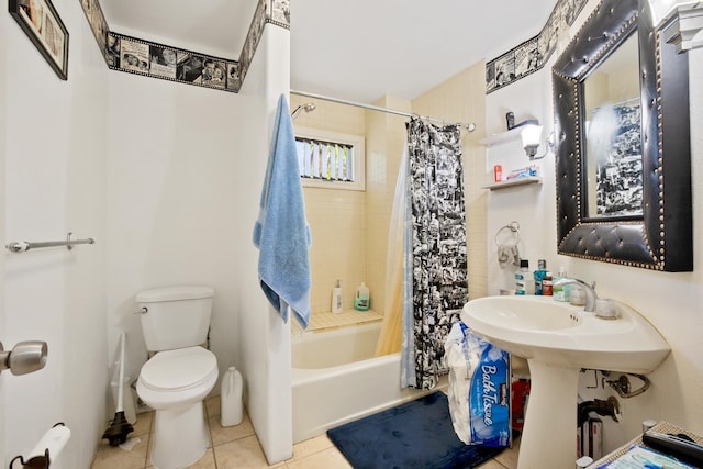 bathroom with tile patterned floors, shower / bath combination with curtain, and toilet