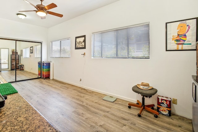 misc room with light hardwood / wood-style flooring and ceiling fan