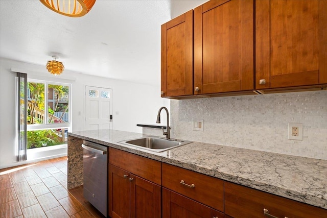 kitchen featuring tasteful backsplash, brown cabinets, dishwasher, and a sink