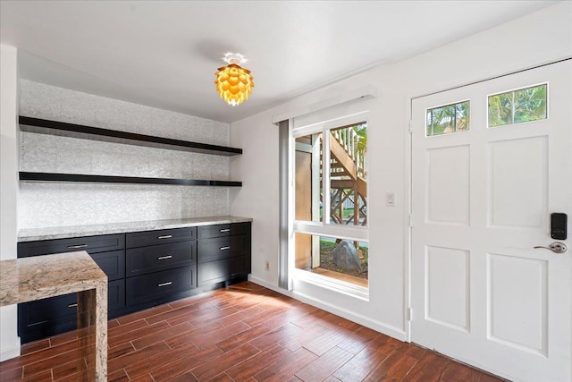 bar featuring plenty of natural light, baseboards, and dark wood finished floors