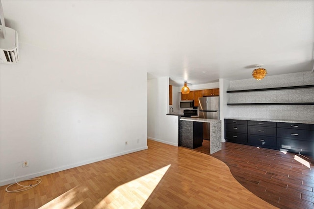 unfurnished living room with dark wood-style flooring and baseboards