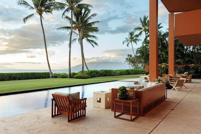 view of patio with a water view and an outdoor living space