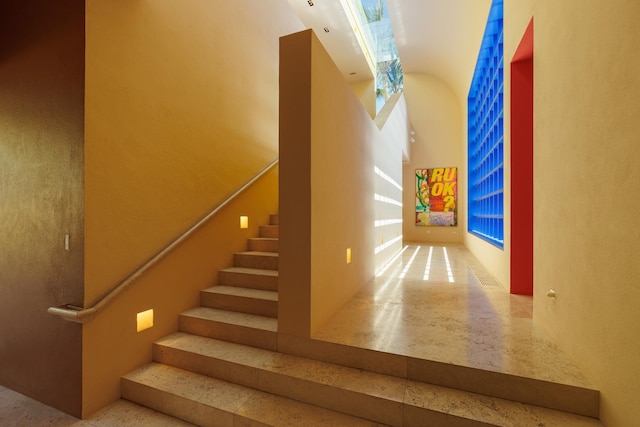 staircase featuring speckled floor