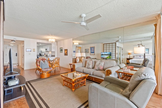 100 Hauoli St Unit 303, Wailuku, HI 96793 - living room featuring ceiling fan, a textured ceiling, and light wood-style floors