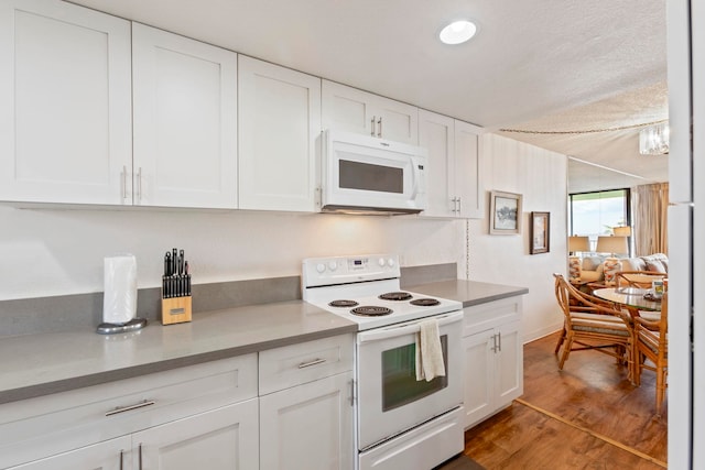 100 Hauoli St Unit 303, Wailuku, HI 96793 - kitchen with white appliances, white cabinetry, and light wood-style floors