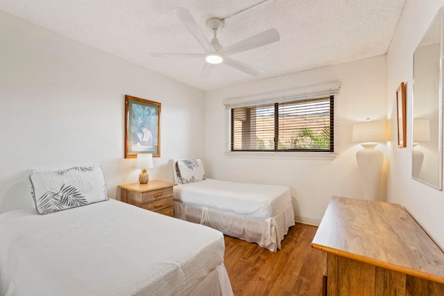 100 Hauoli St Unit 303, Wailuku, HI 96793 - bedroom featuring wood finished floors, a textured ceiling, and ceiling fan