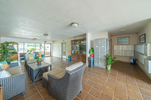 100 Hauoli St Unit 303, Wailuku, HI 96793 - tiled living area with a textured ceiling and mail area