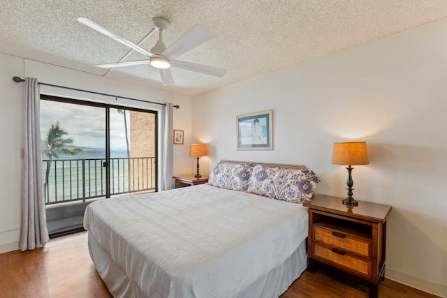 100 Hauoli St Unit 303, Wailuku, HI 96793 - bedroom with access to exterior, wood finished floors, a textured ceiling, ceiling fan, and a water view
