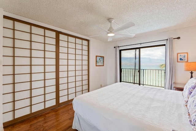 100 Hauoli St Unit 303, Wailuku, HI 96793 - bedroom featuring access to outside, wood finished floors, a textured ceiling, and a ceiling fan