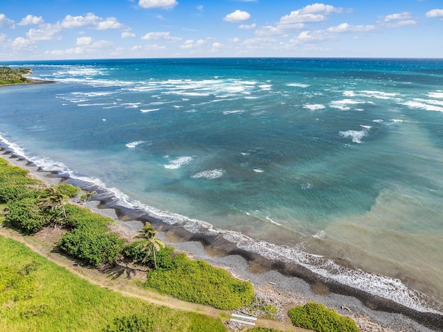 birds eye view of property featuring a water view and a beach view