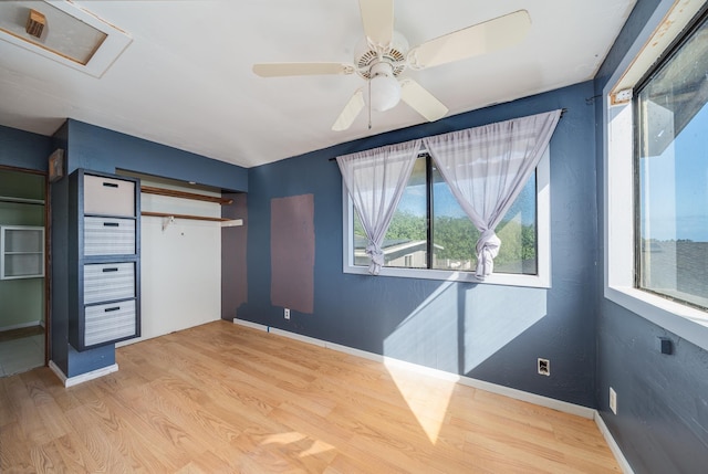 unfurnished bedroom with baseboards, ceiling fan, and light wood-style flooring