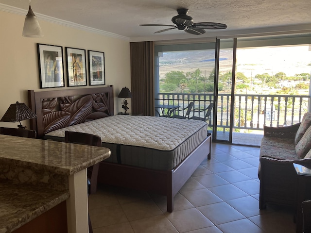 tiled bedroom with ceiling fan, ornamental molding, and access to exterior