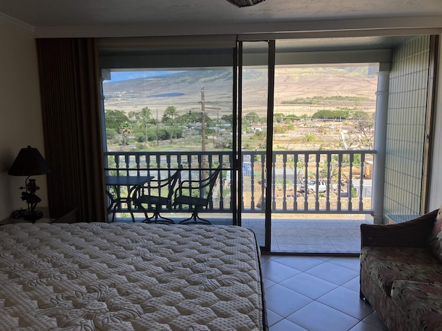 bedroom featuring tile patterned flooring and access to outside