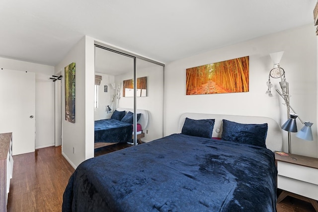 bedroom featuring a closet and dark hardwood / wood-style floors